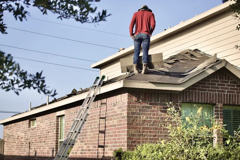 Professional roofer working on a residential roof in Molfait Tracts
